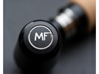 Engraved metal butt cap on a fishing rod handle